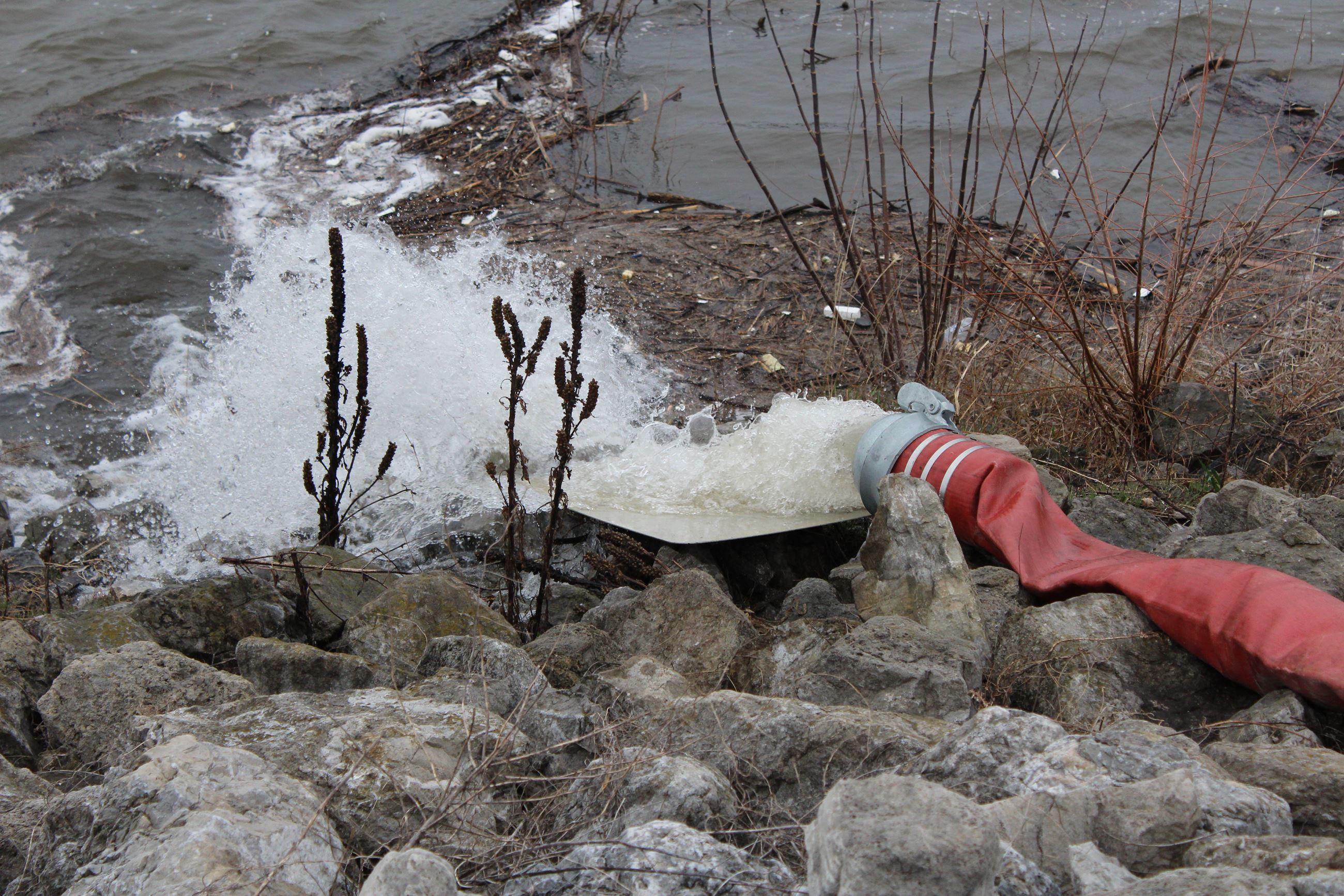 040419 Pumping water back over levy at Cargill site 2