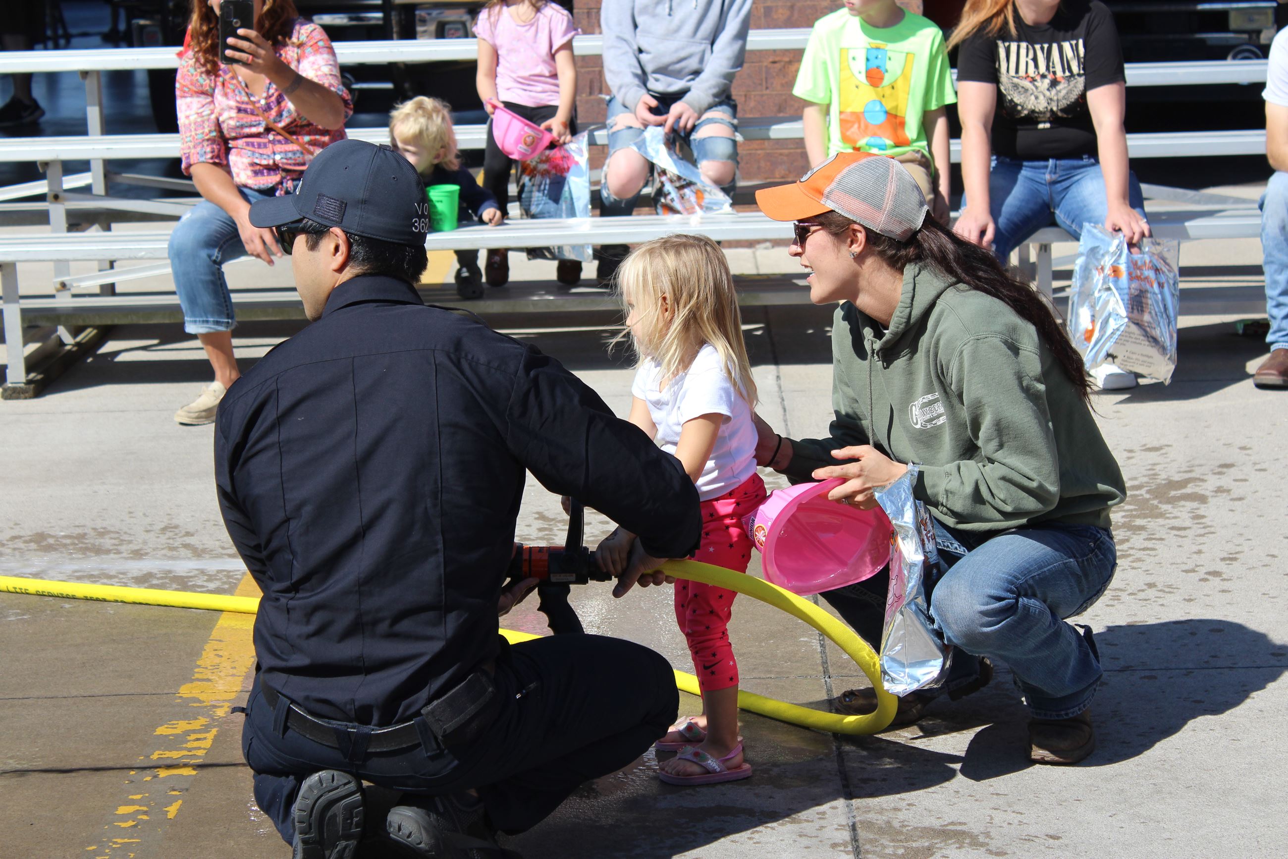 Muscatine Fire young girl shooting firehose PSOH October 2, 2022 (JPG)
