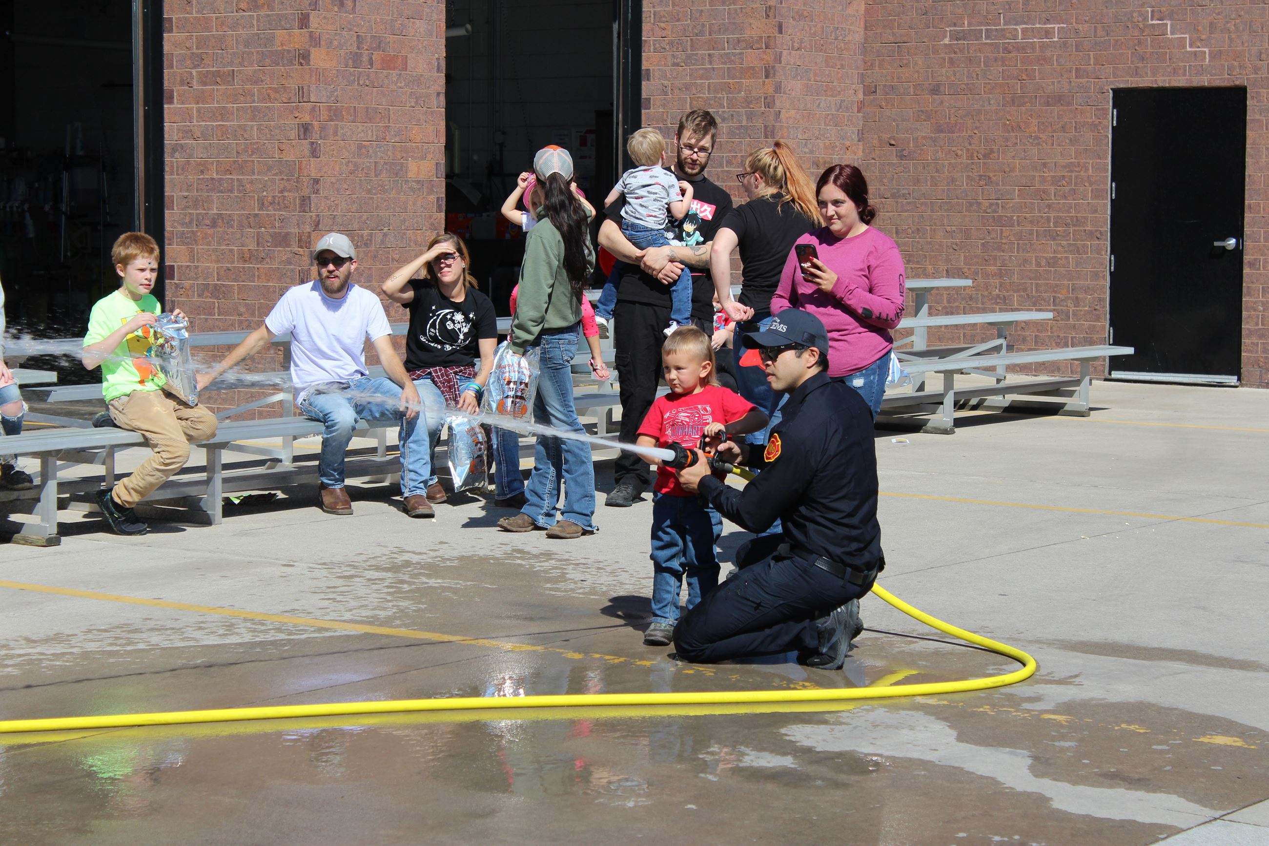 Muscatine Fire young boy shooting firehose PSOH October 2, 2022 (JPG)