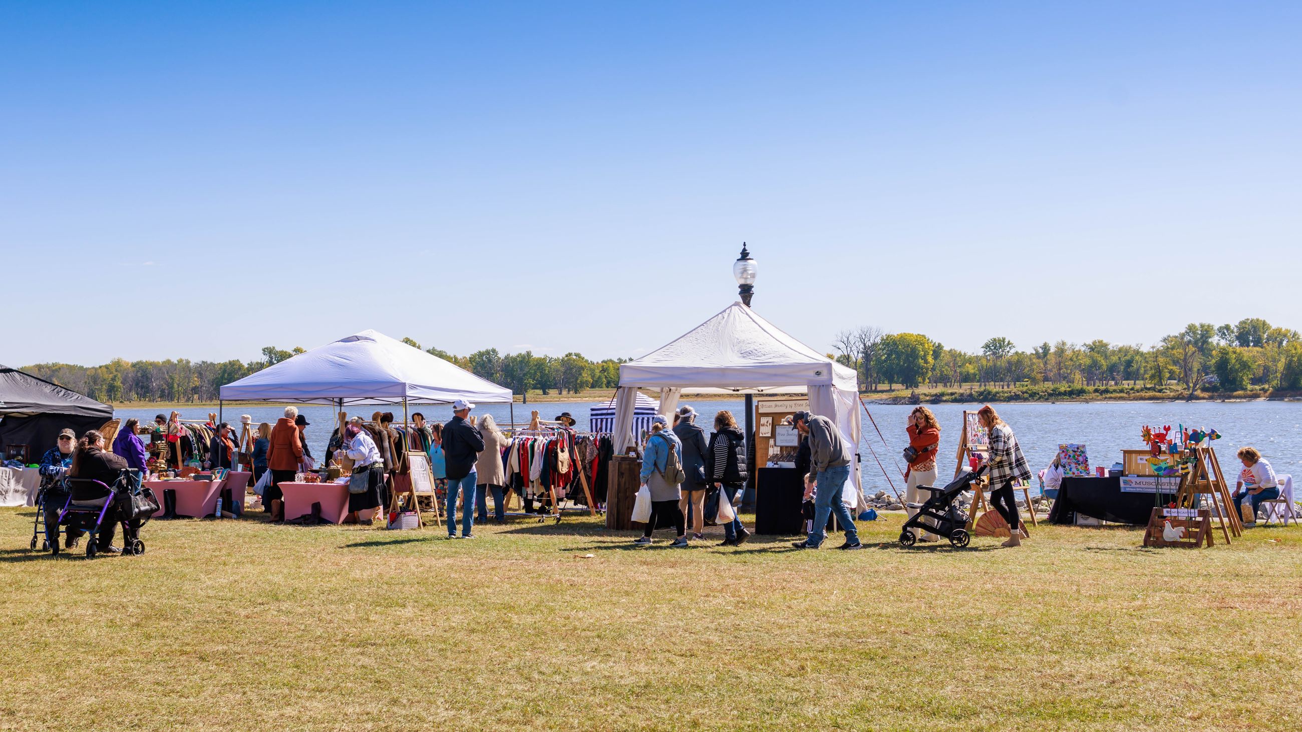 Vintage Market (JPG) showing crowd visiting vendors along riverfront