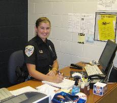 Female officer smiling at desk