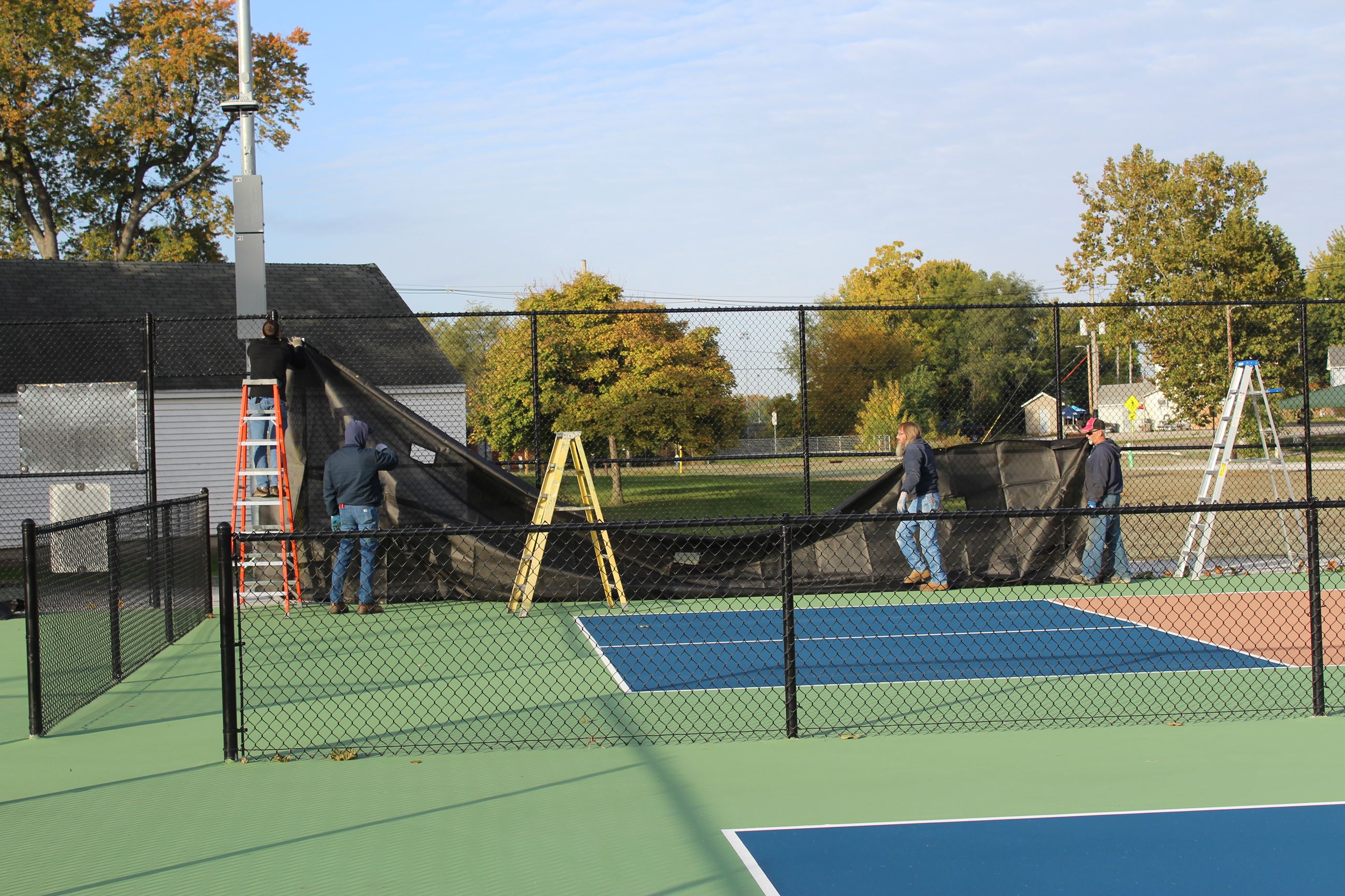 Taylor Park PIckleball Court putting up wind screen (JPG)